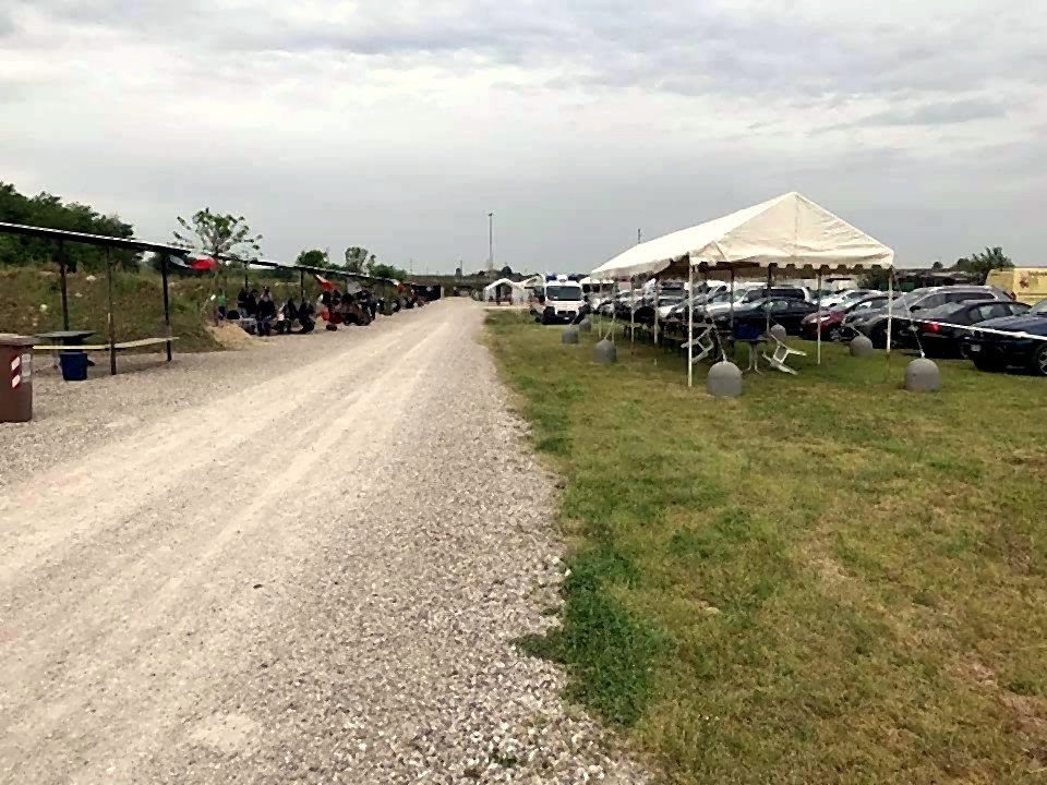 Viale di ghiaia con il parcheggio e un tendone per gli eventi sulla destra